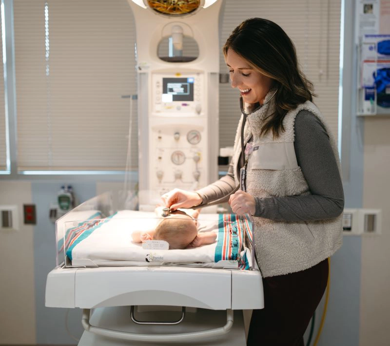 Provider checking baby's vitals
