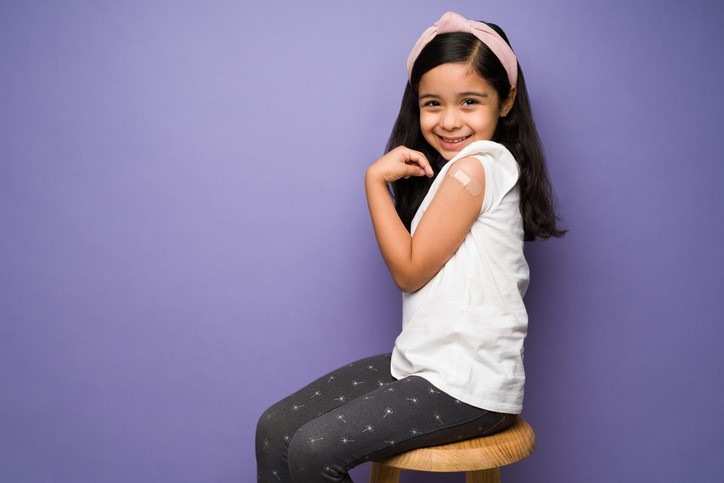 Female child posing with band-aid from immunization